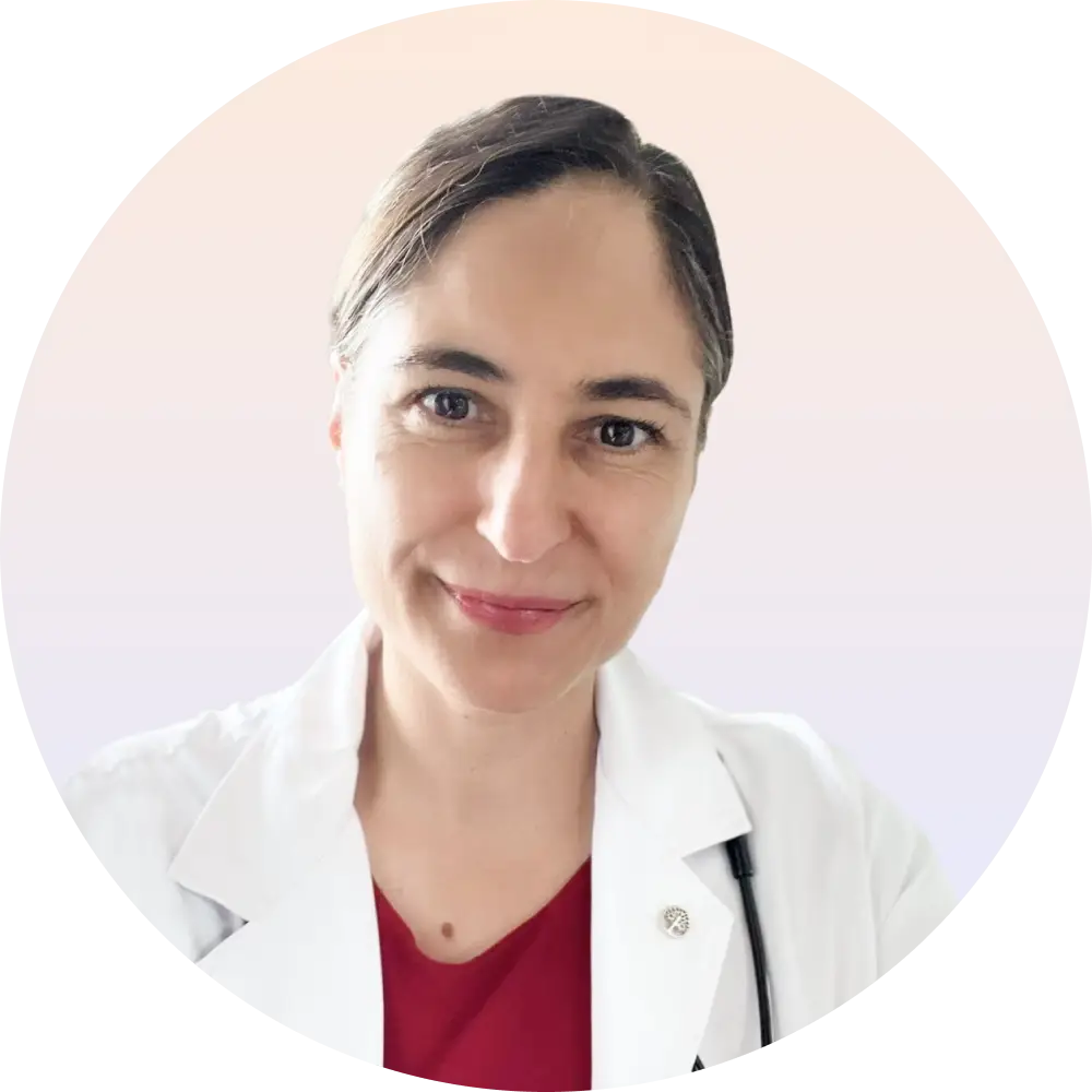A smiling woman wearing a white lab coat, representing confidence and expertise in a scientific environment.